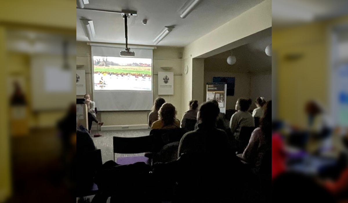 Members of the Boat Club reviewing outing footage