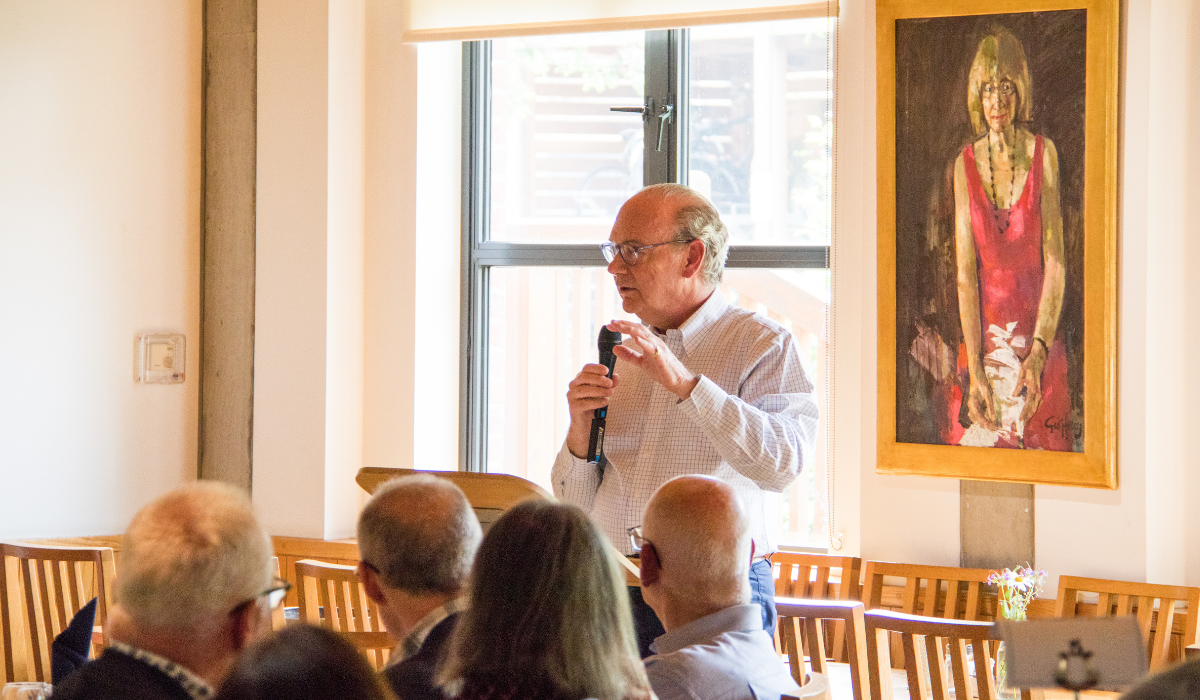 Mark Florman talking to Anna Bidder society members in the College Dining Hall