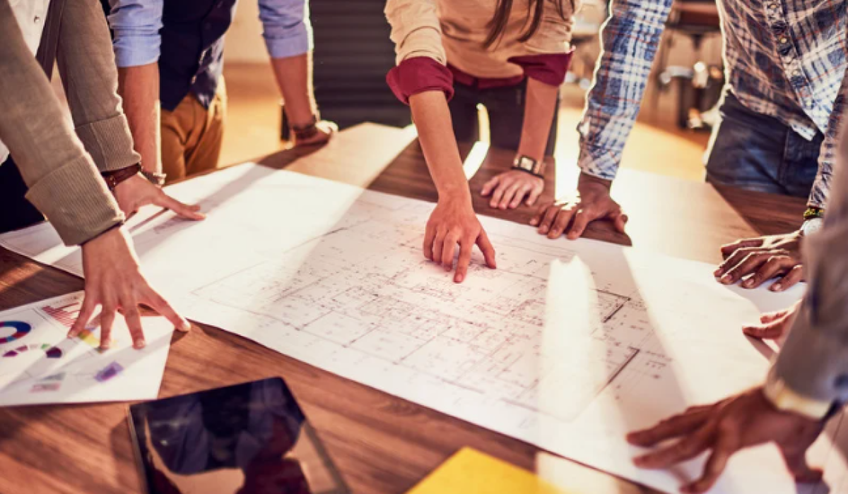 Group of people looking at architectural drawings