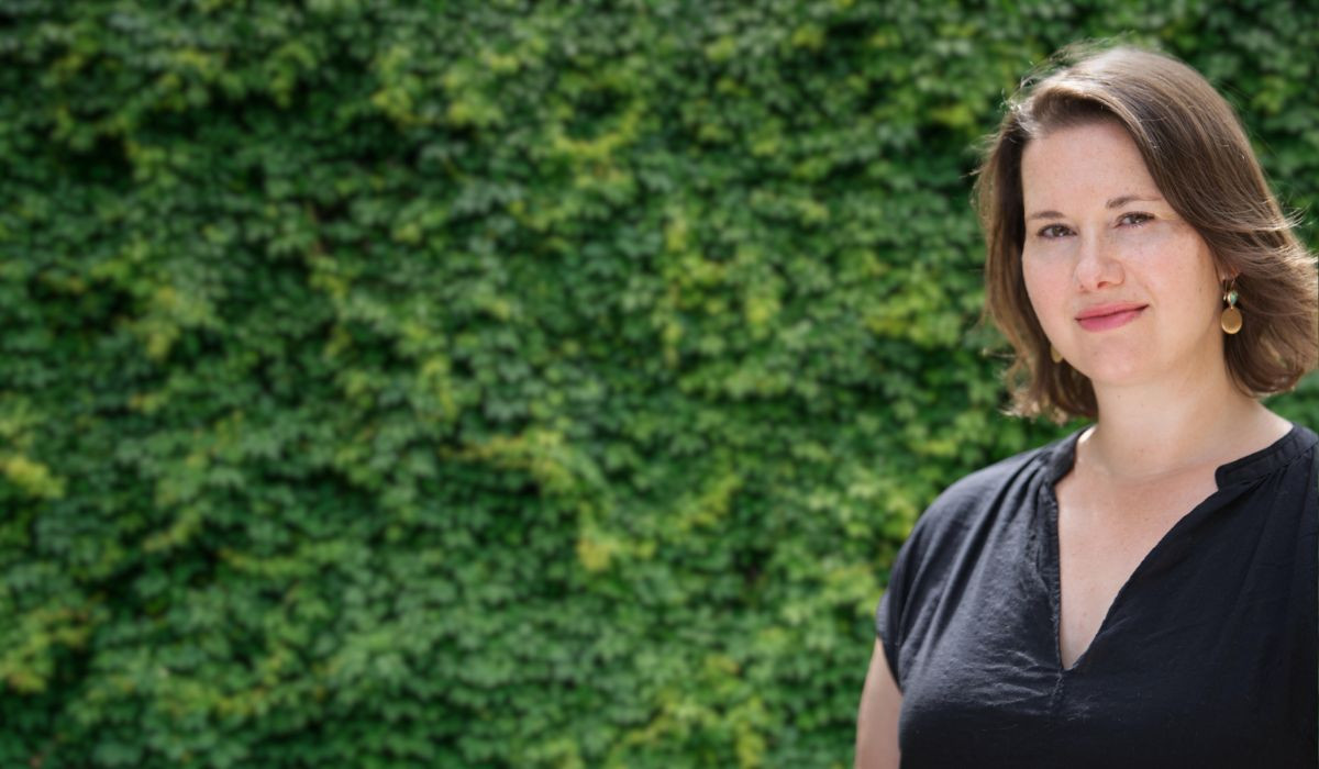 Alison Stockham wearing a black shirt with green edge in the background