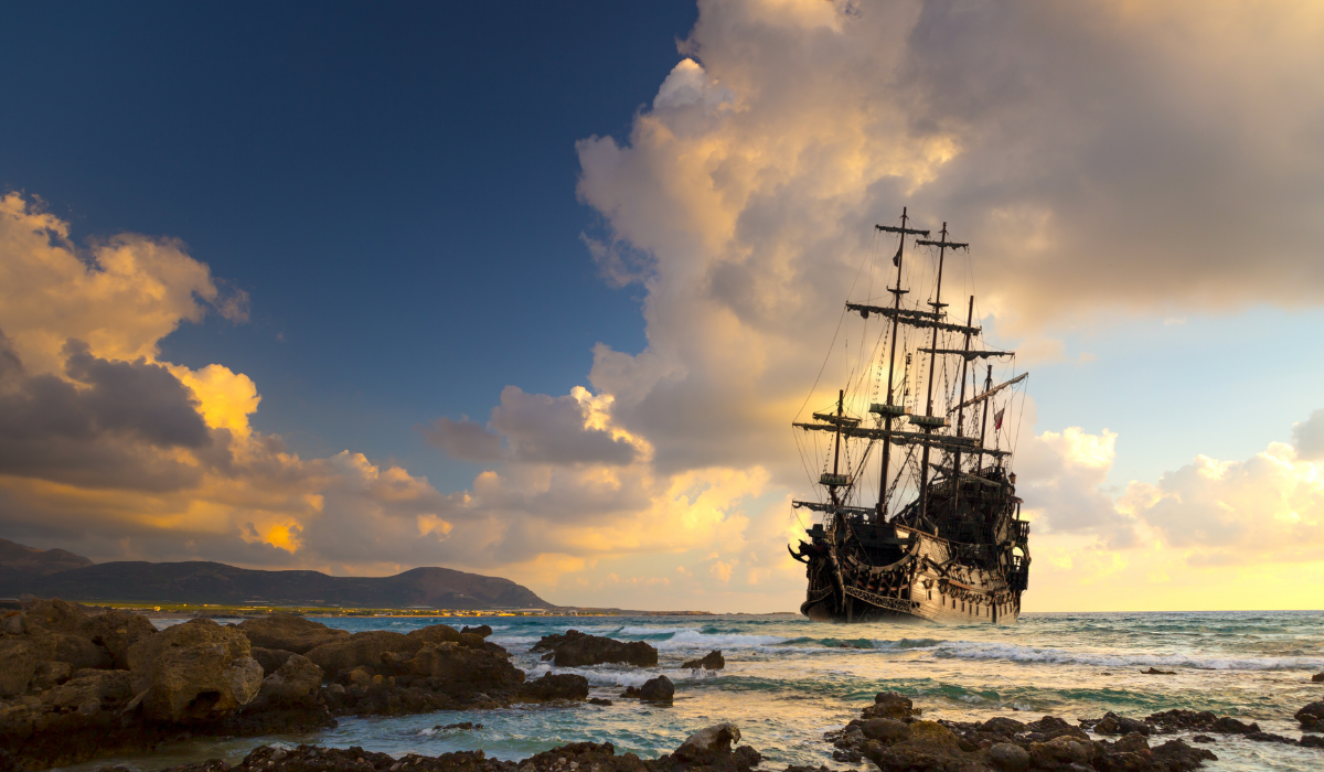 Pirate ship sailing at sunset