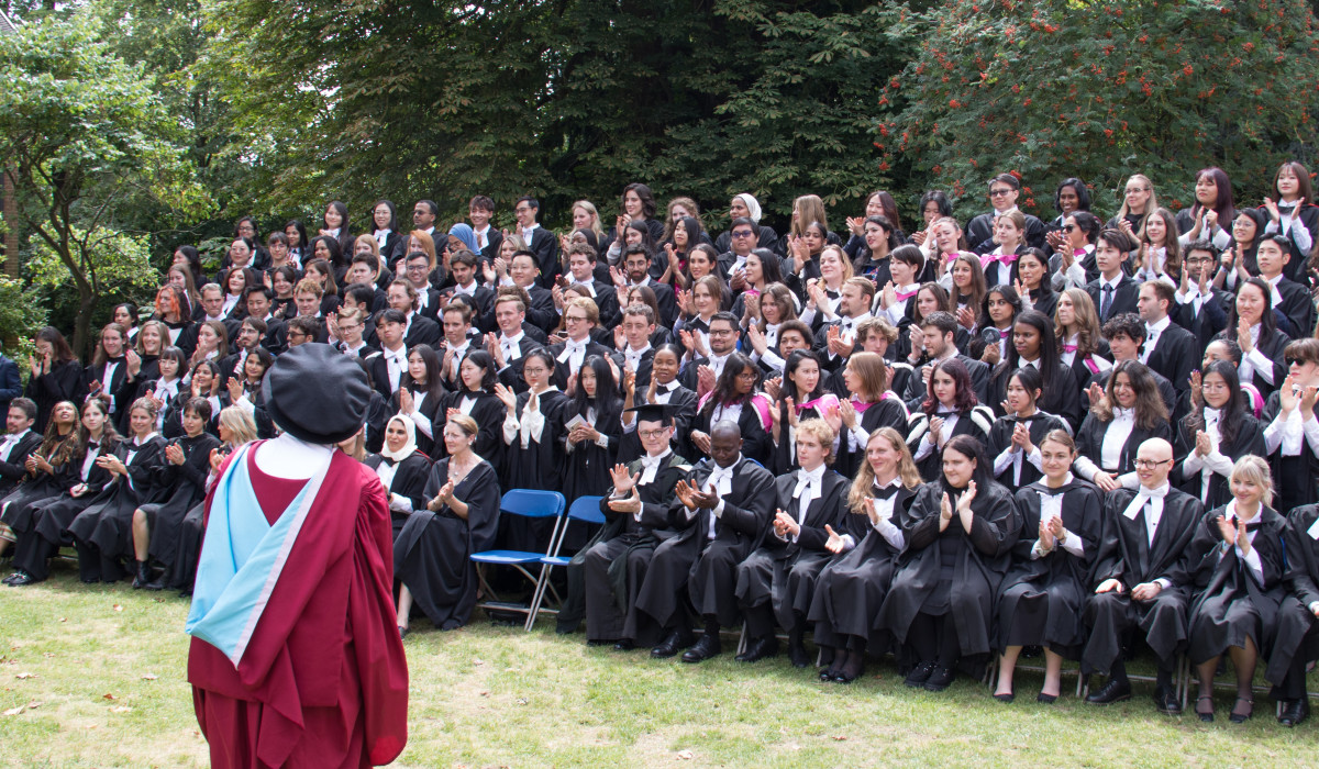 Graduands on College House lawn