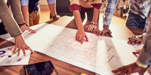 Group of people looking at architectural drawings