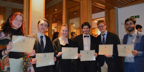 6 students holding prize certificates